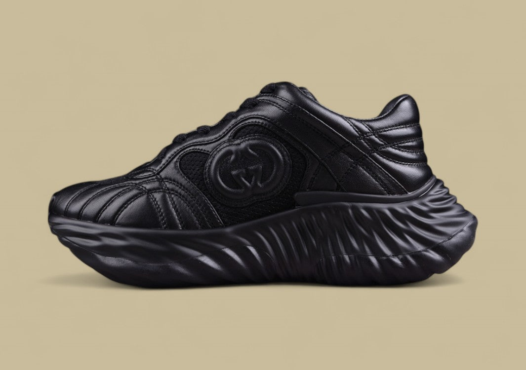 Gucci Black Sculpted Sneakers Futuristic Leather Runners with Monochrome GG Design