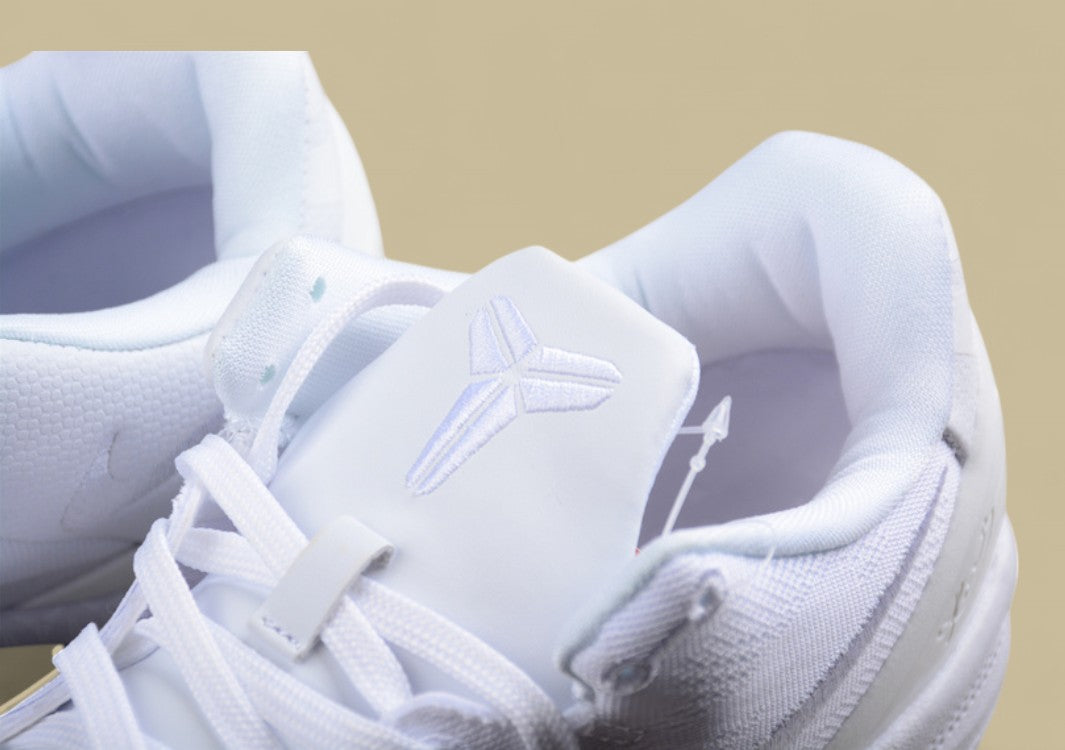 Nike Kobe Protro Triple White Sleek All-white Low-top Basketball Shoe With Minimalist Design